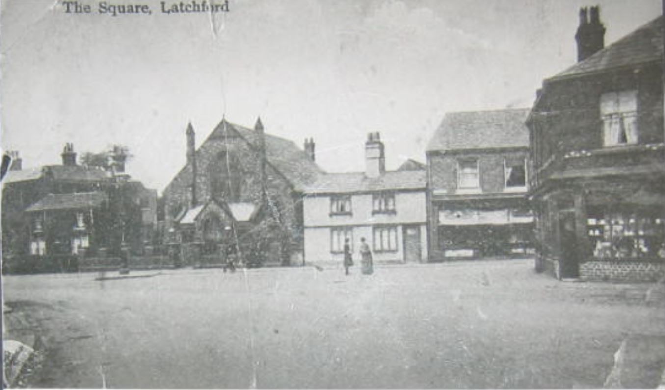 Latchford Square with the church and caretakers cottage in the background. Year 1900's